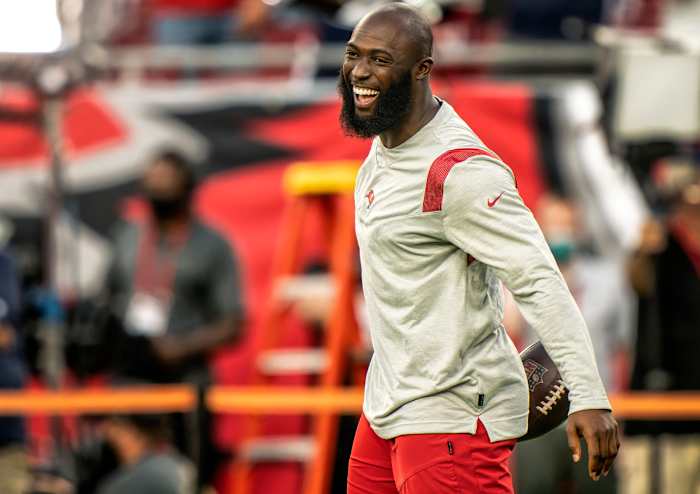Leonard Fournette smiles on the field during pregame warmups before a 2020 game.